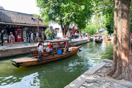 Shanghai, China - September 2019: Sightseeing tour on Chinese traditional rowboat along the canal in Zhujiajiao Ancient Water Town, a historic village and famous tourist destination in the Qingpu District of Shanghai, Chinaのeditorial素材