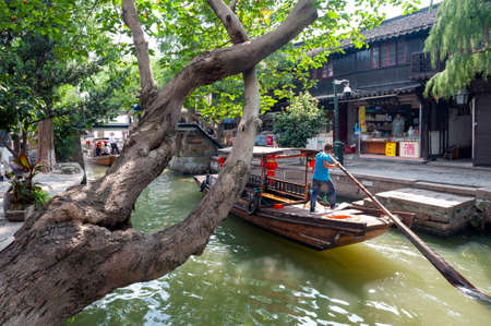 Shanghai, China - September 2019: Sightseeing tour on Chinese traditional rowboat along the canal in Zhujiajiao Ancient Water Town, a historic village and famous tourist destination in the Qingpu District of Shanghai, Chinaのeditorial素材