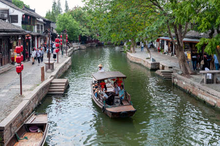 Shanghai, China - September 2019: Sightseeing tour on Chinese traditional rowboat along the canal in Zhujiajiao Ancient Water Town, a historic village and famous tourist destination in the Qingpu District of Shanghai, Chinaのeditorial素材