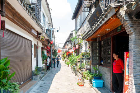 Shanghai, China - September 2019: Old residential buildings transformed into shops and restaurants along the alleys in Zhujiajiao Ancient Water Town, a historic village and famous tourist destination in Qingpu District of Shanghai, Chinaのeditorial素材