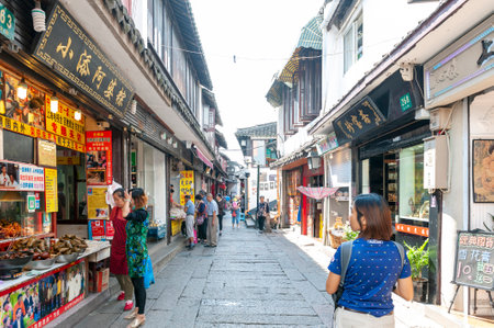 Shanghai, China - September 2019: Old residential buildings transformed into shops and restaurants along the alleys in Zhujiajiao Ancient Water Town, a historic village and famous tourist destination in Qingpu District of Shanghai, Chinaのeditorial素材