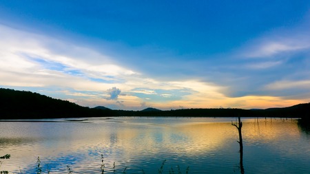 The reservoir with sunset, clouds, sky and mountainの写真素材