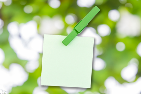 Paper color and wood clip note on Green bokeh