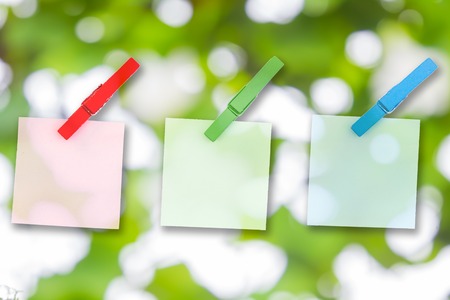 Paper color and wood clip note on Green bokehの写真素材