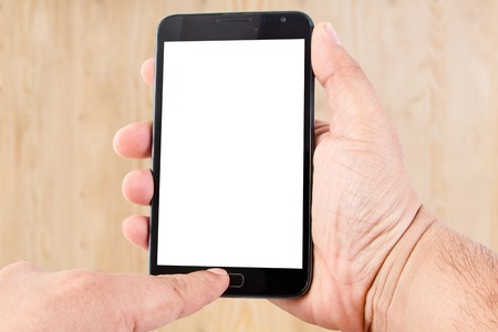 Man hand hold blank touch screen smart phone on wood texture for background.