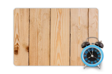 Alarm clock on wood texture for background.