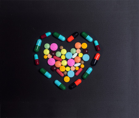 heart of colorful pills. medical backgroundの写真素材