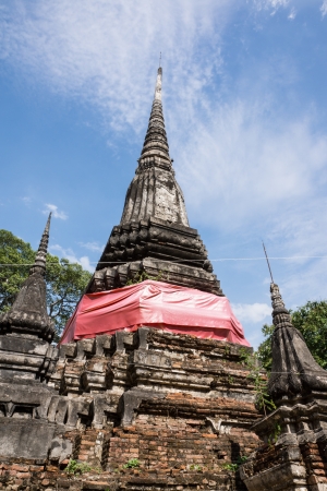 Old pagoda with red cloth in Thailandの写真素材