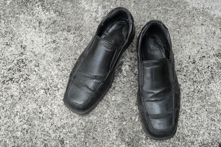 Black old shoes it dirty and worn-outの写真素材