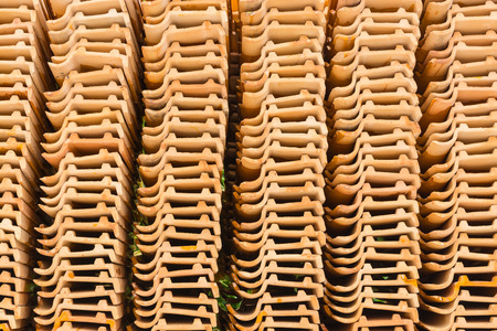 Clay roof tiles orange placed in a rowの写真素材