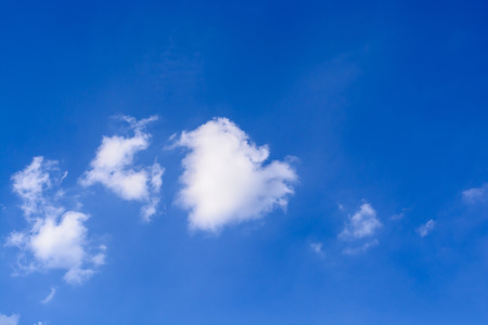 Blue sky background with white cloudsの写真素材