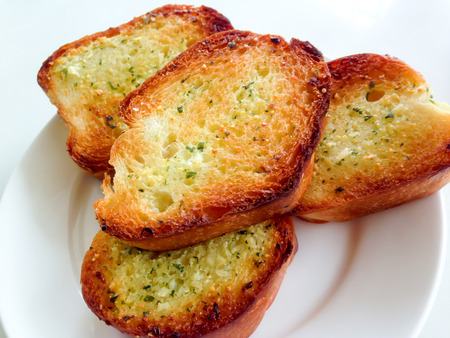garlic bread on white dishの写真素材