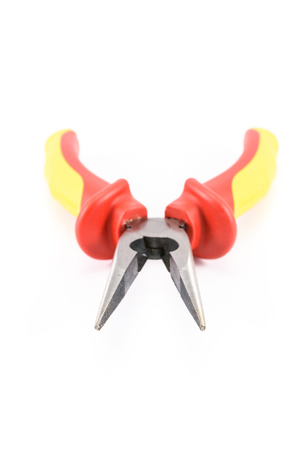 closeup red yellow pliers isolated on white backgroundの写真素材