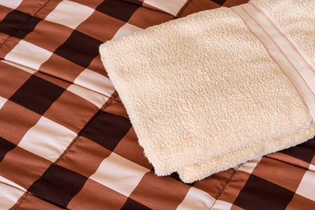 Freshly fluffy towels cream colour in bedroomの写真素材