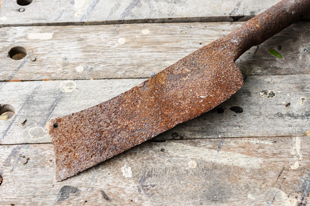 rusty old knife on a wooden tableの写真素材