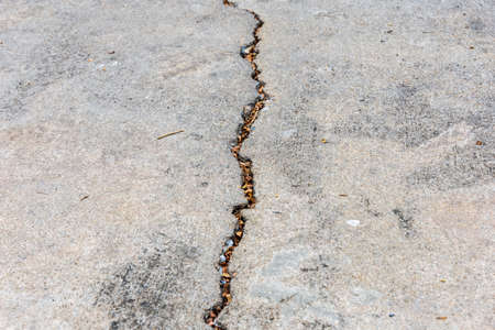 Closeup and detail of the cracked concrete roadの写真素材