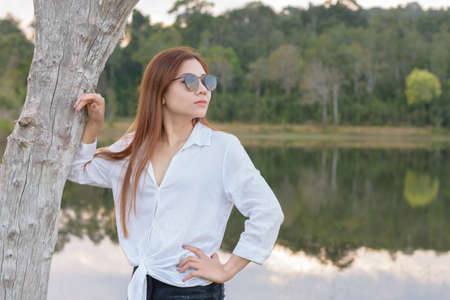 Portrait asian woman standing in the forest