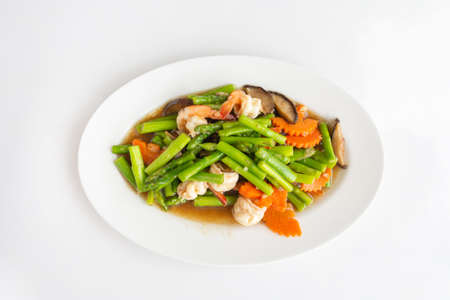 Stir-Fried Mixed vegetable asparagus, mushroom, and shrimp, on a white table Thai local food, Close-up top view.の写真素材