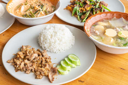Thai street food on a wooden table, close up.の写真素材