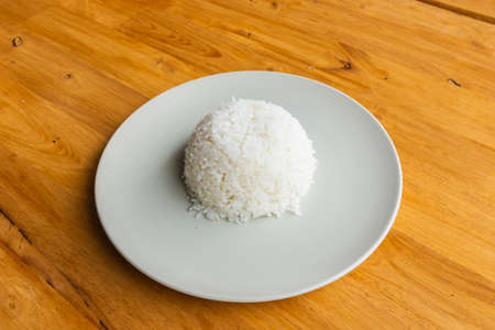 cooked rice on a wooden table, close up and top view.の写真素材