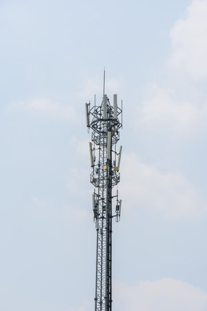 Telecommunication tower communication technology with cloud and blue sky.の写真素材