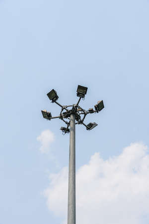 lighting lamp on a spotlight pole with cloud and blue skyの写真素材