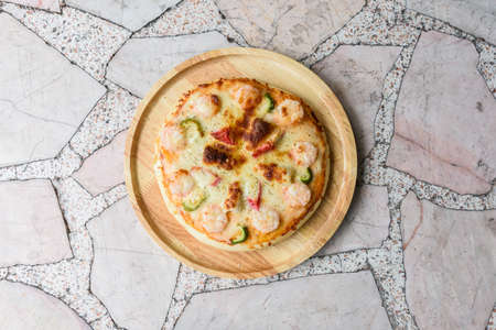 Pizza homemade on a marble table, closeup top view.の写真素材