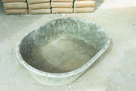 Empty bucket mortar mixing tank construction siteの写真素材