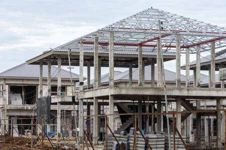 Building site with village and new homes under constructionの写真素材
