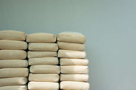 Pile of Cement in brown bags in a construction site with gray wall backgroundの写真素材