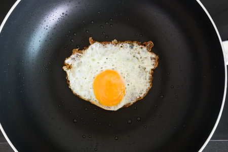 Fried egg on a pan food meal homemade for energy  , flat or top viewの写真素材