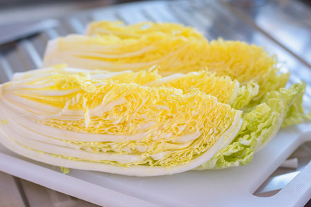 Close up half of the fresh chinese cabbage on the chopping board.の写真素材