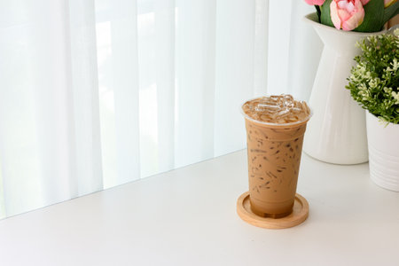 Iced espresso Thai style on a wooden plate with copy space and soft white background.の写真素材