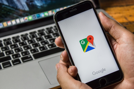 CHIANG MAI, THAILAND - Jun 3, 2016: Man hand holding Iphone 6s or 6Plus with Google Maps application o. Google Maps is a service that provides information about geographical regions and sites around the world.のeditorial素材