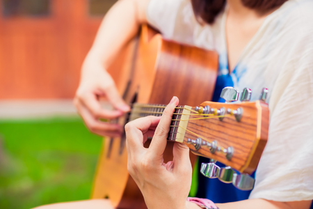 close up Woman playing acoustic guitar. vintage effect. selective focus. release or relax concept.の写真素材