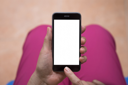A woman hand holding smart phone Smartphone with blank screen and can be add your texts or others on smart phoneの写真素材