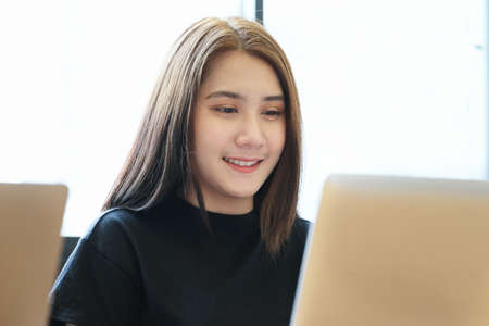 digital technology with Business woman using computer laptop to trade charts to find buy and sell points for her portの写真素材