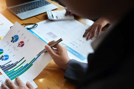 The company employee points to the document to calculate the budget and verify the correctness of...