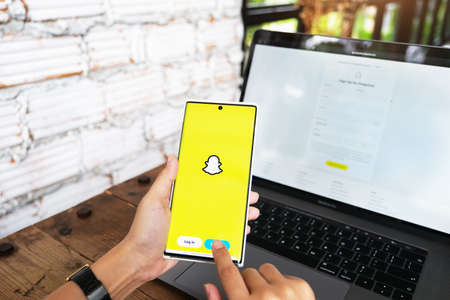 CHIANG MAI, THAILAND -JUNE 06, 2021: a hand holding a smartphonei mobile which displays the Snapchat appのeditorial素材
