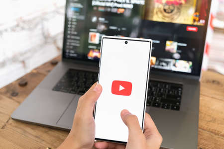 CHIANG MAI, THAILAND - June 06, 2021 :Woman holding smartphone mobile with video service YouTube on...