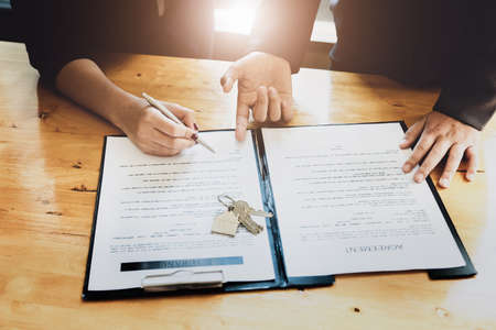 estate agent gives pen and documents agreement with customer to sign contract. Concept agreement.