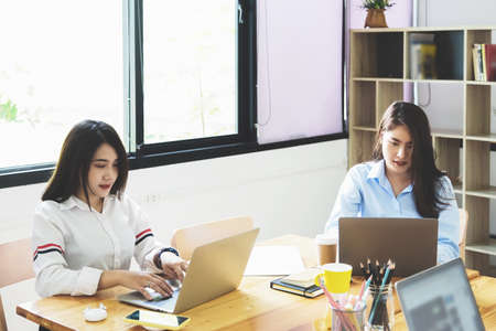 freelance concept, a group of female employees using computers to design work as ordered by customersの写真素材