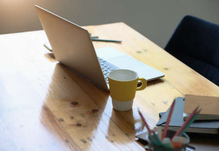 Working concept, computer, coffee mug, books and documents on the desk.