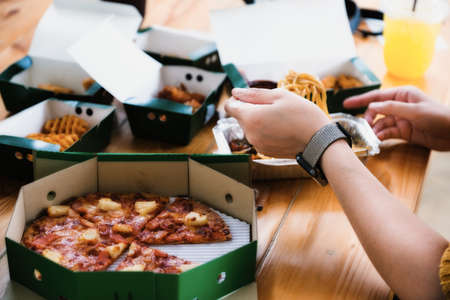 people eating spaghetti and pizza on vacation.の写真素材