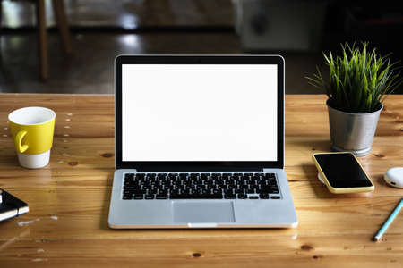 Close-Up laptop on wooden desk blur background. Laptop computer with blank screen and can be add your texts or others on Laptop.の写真素材