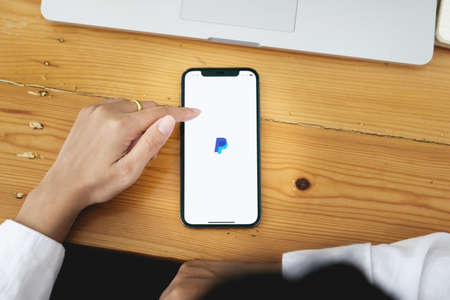 CHIANG MAI, THAILAND - MAY 30, 2021 : Women hands holding Oneplus 6 with PayPal apps on the screen. PayPal is an online electronic payment system.のeditorial素材