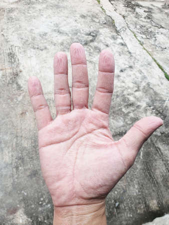 Pruney Fingers from working in the water for a long time.の写真素材