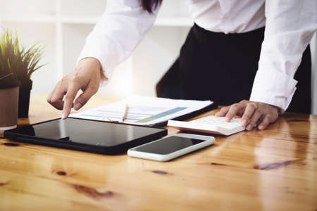 Marketers are using tablet, calculator, document and smartphone to do budget checks.の写真素材