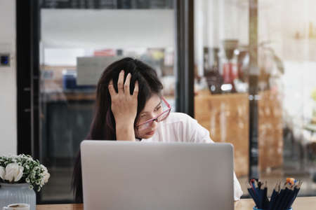 Employees show signs of boredom from working full time.の写真素材