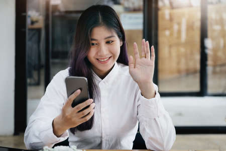 Company employees are meeting friends through the system. Internet to keep distanceの写真素材